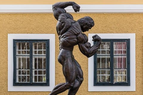 The Legend Begins: The iconic bronze statue of Arnold Schwarzenegger flexing outside his childhood home in Thal.