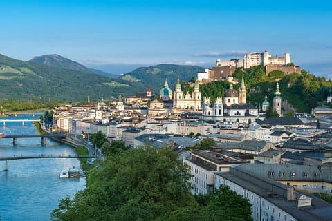 Take in Salzburg’s historic center from the top of Mönchsberg, with the towering Hohensalzburg Fortress and Salzburg Cathedral in view, along with the Salzach River and Gaisberg in the background.