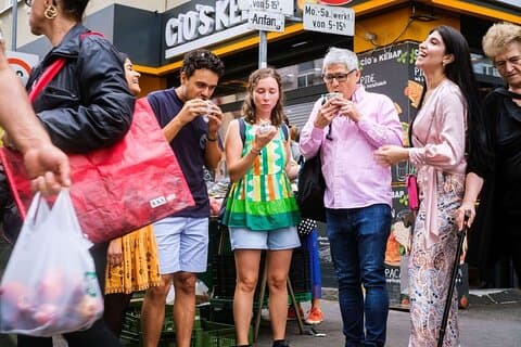 Tasting local street food together at a hidden Viennese market stop.