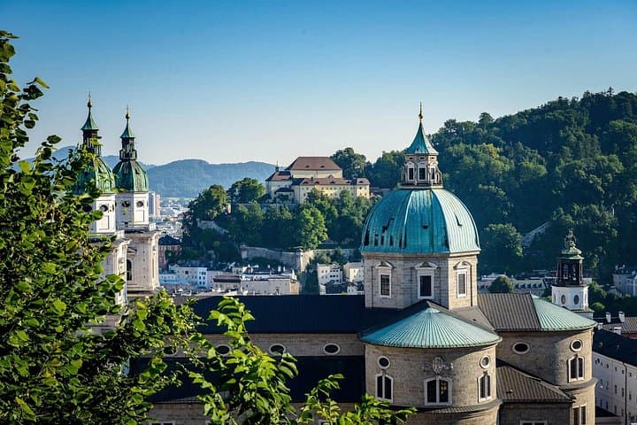 Austrian Elegance: Discover the breathtaking baroque architecture of Salzburg, beautifully nestled beneath the majestic Hohensalzburg Fortress.