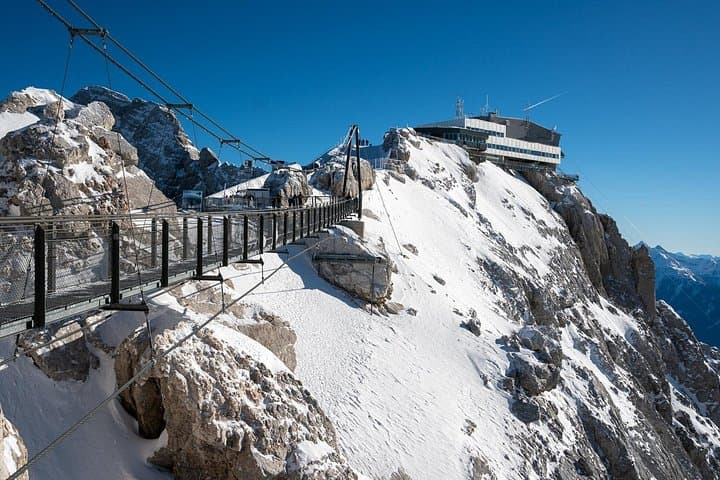 A Walk Above the Clouds: Step onto Austria's highest suspension bridge, hovering securely 400 meters above the rugged mountain face.