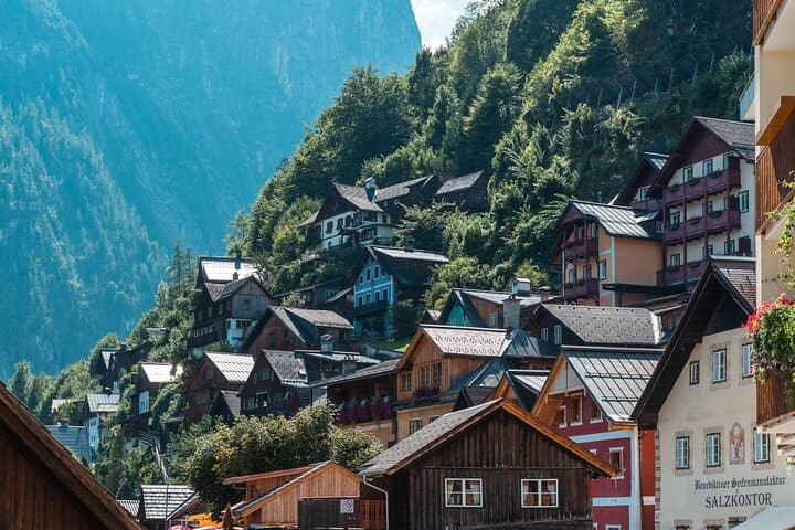 Fairytale Architecture: Discover the charming, centuries-old wooden chalets clinging dramatically to the steep mountainside.