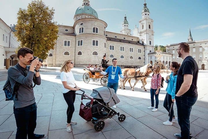 A picturesque carriage in front of the magnificent Salzburg Cathedral at Residenzplatz—an iconic Salzburg moment.