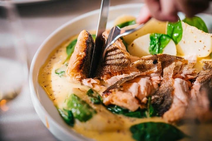 Local river fish in a creamy mustard sauce as part of your gourmet lunch.