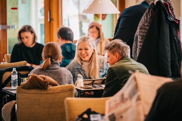 Your local host chatting with guests over coffee and sweet treats.