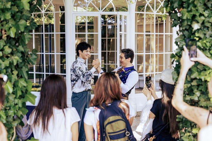 Guests enjoying a sing-along moment in front of the famous gazebo near Hellbrunn Palace, one of Salzburg’s iconic filming locations.