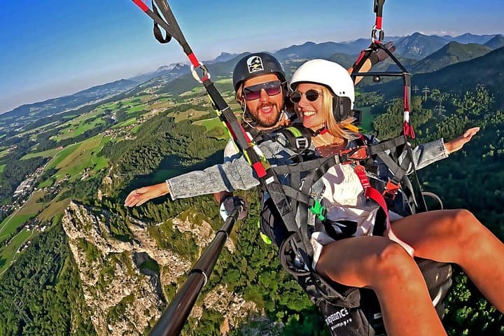 Tandem paragliding above Salzburg from Gaisberg Mountain with a certified pilot. Enjoy panoramic alpine views while flying comfortably seated in a secure harness.