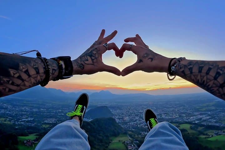 Sunset tandem paragliding above Salzburg from Gaisberg Mountain. Enjoy breathtaking views of the city and Alps while flying comfortably seated in a secure harness.