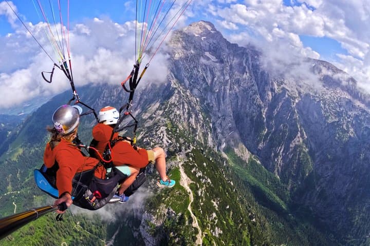 Tandem paragliding high above the Austrian Alps near Salzburg. Discover breathtaking mountain scenery and dramatic cliff views while flying with a certified professional pilot.