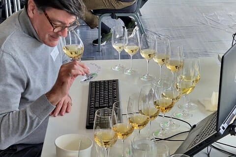 Darrel Joseph judging a flight of white wines for a competition.